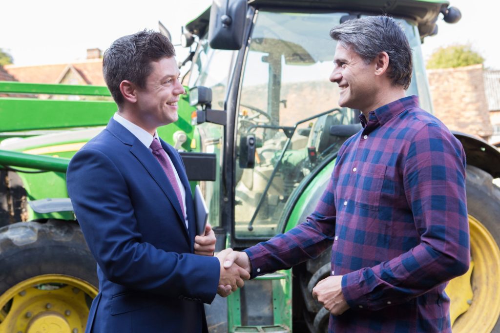 Businessman and farmer shaking hands